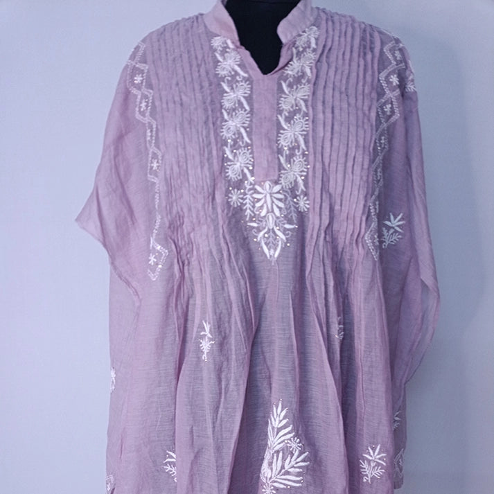 Purple embroidered dress on a light purple background