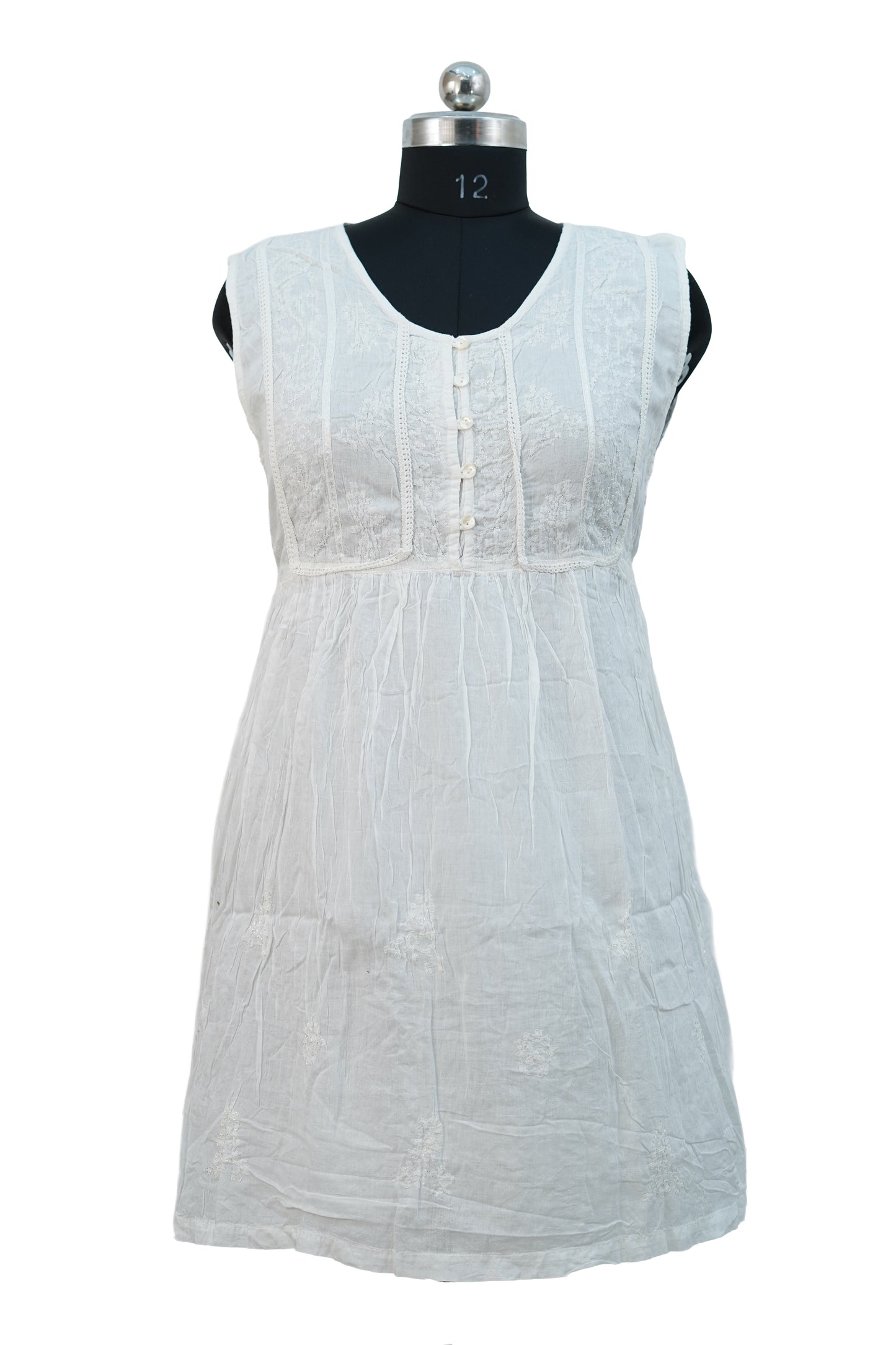 White sleeveless dress on a mannequin against a white background
