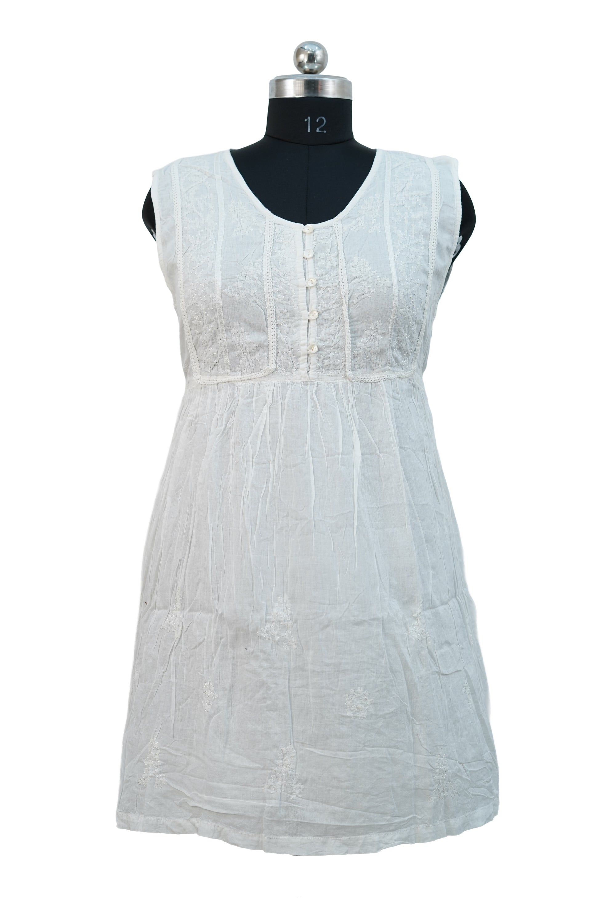 White sleeveless dress on a mannequin against a white background